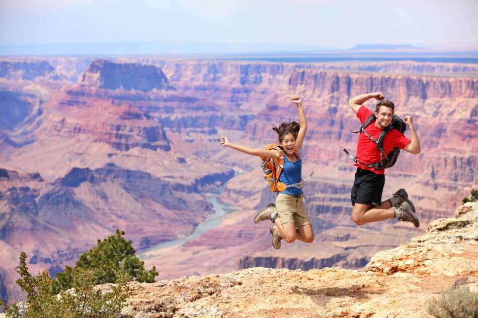 Grand canyon couple jumping for joy